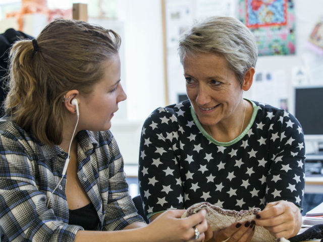 Student doing knitwear and receiving feedback