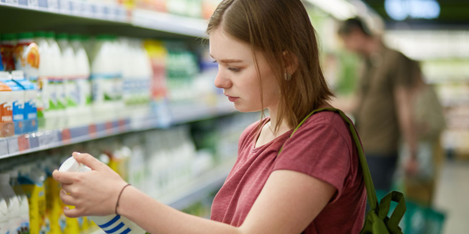 woman looking at juice in supermarket