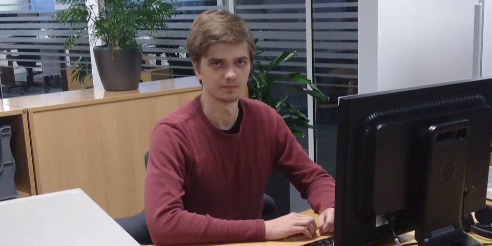 Justas is sitting in front of his work computer