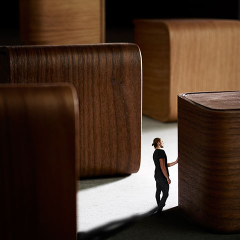 Man walking between wood blocks.