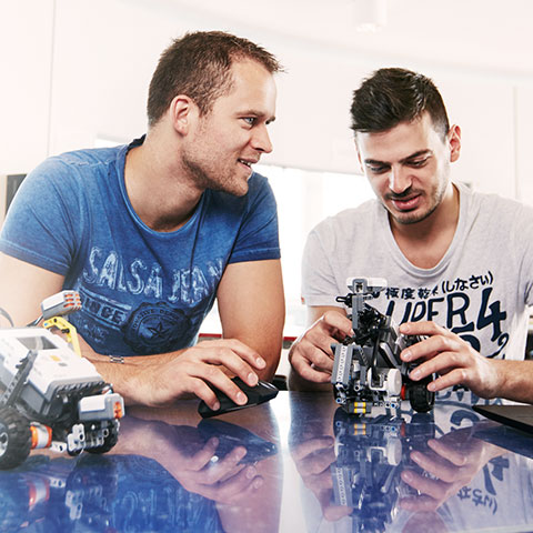 Male students with Lego cars